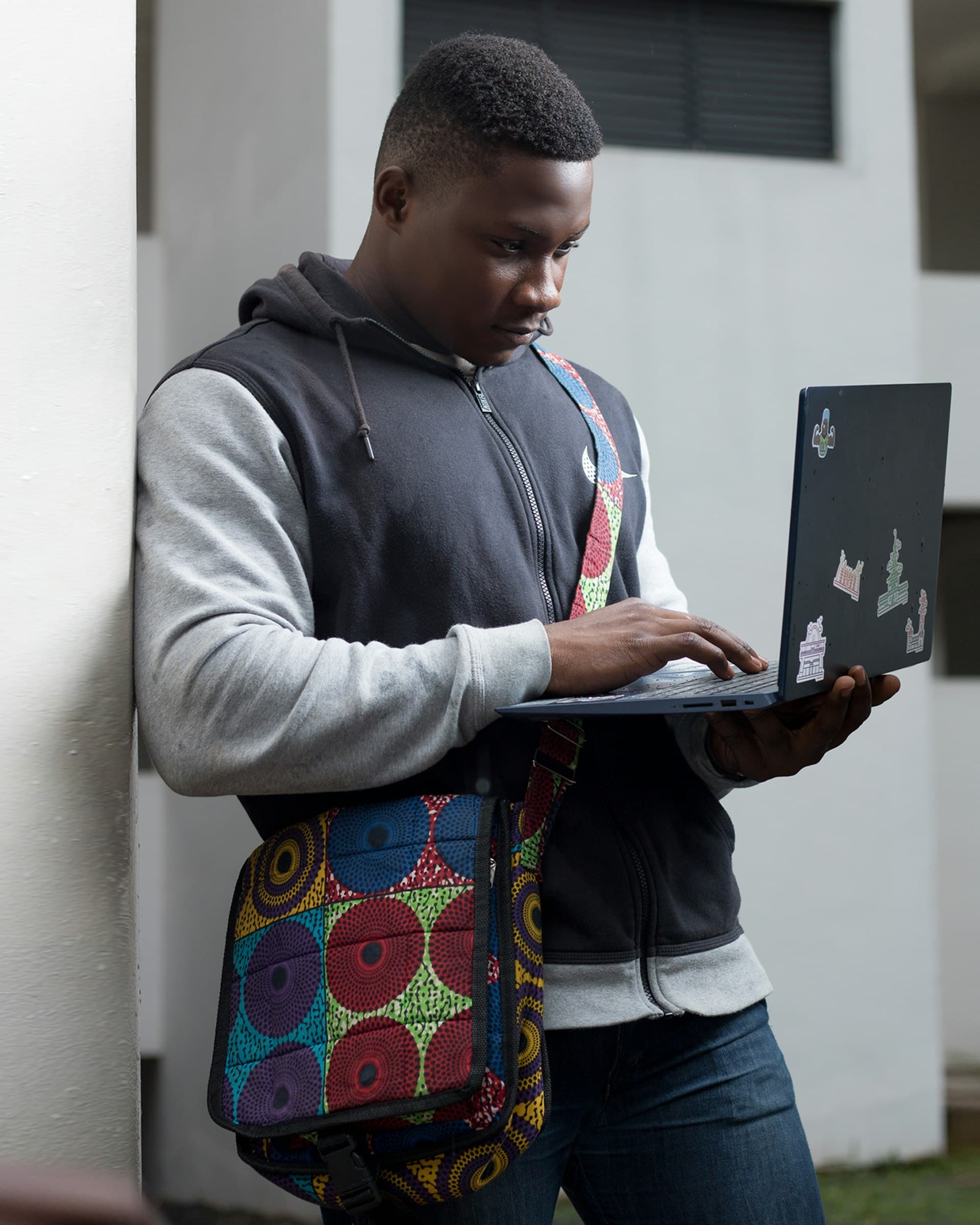A young African trainee building a project on a laptop